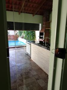 a kitchen with a sink and a view of a pool at Casa Andreia Borges in Aparecida de Goiania