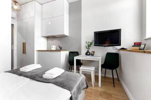 a bedroom with a bed and a table and a tv at Charming Old Town view apartment in Tallinn