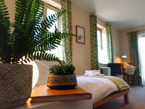 a bedroom with a potted plant on a table at By the River in Glasbury