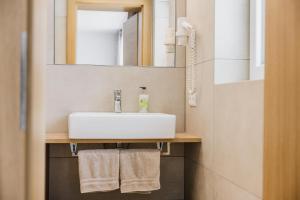 a bathroom with a white sink and a mirror at Pension Gabl in Pfunds