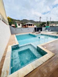 a large swimming pool on top of a house at Casa de praia SANTINHO in Búzios