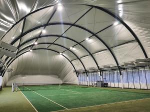a tennis court inside a tent with a tennis court at Bukowa Ostoja in Nakielno