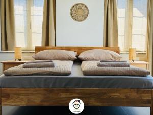 a bed with four pillows on top of it at Family M Apartments 40 - Luzern - Horw in Luzern