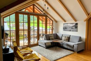 a living room with a couch and a table at Kerstin 10 by SMR Rauris Apartments - inc Spa and near Gondola in Rauris