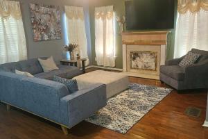 a living room with two couches and a fireplace at The Village in Atlanta