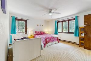 a bedroom with a bed and blue curtains at Pine Valley Lodge in Angel Fire