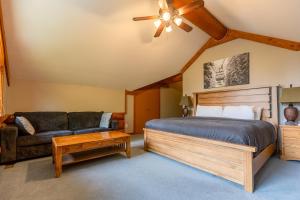 a bedroom with a bed and a couch at The Alders Chalet by Fernie Central Reservations in Fernie