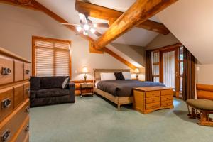 a bedroom with a bed and a chair at The Alders Chalet by Fernie Central Reservations in Fernie