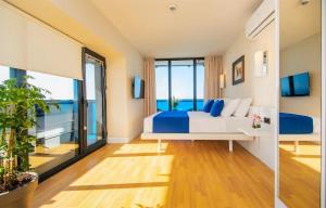 a bedroom with a bed with blue pillows at Panorama Resort Hotel in Batumi