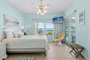 a bedroom with a bed and a view of the ocean at Baywatch Unit G9 in Pensacola Beach