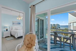 a room with a hammock and a bed and a balcony at Baywatch Unit G9 in Pensacola Beach