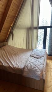 a large bed in a room with a window at Villat Liss in Peje +4 photos