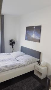 a bedroom with a bed and a picture of a lighthouse at Ferienwohnung Sofie Marie in Oberhausen