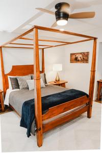 a bedroom with a wooden canopy bed with a ceiling fan at NEWLY REMODELED FOUR BEDROOM All SEASON CONDO W MOUNTAIN VIEWS in East Jewett +47 photos