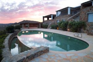 a swimming pool in front of a house at Villa Lia in Kalafatis