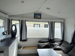 a living room with a couch and a mirror at Living Holiday in Middelkerke