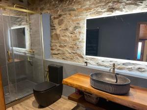 a bathroom with a sink and a shower at Roca negra Montseny in Fogars de Montclus +97 photos