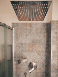 a bathroom with a shower with a ceiling with lights at Verona Bed and Relax Apartment in Verona +27 photos