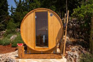 a small wooden boat sitting on a pile of rocks at Boo Premium Living Villas in Tsoukaladhes +39 photos