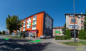 a building with green arrows in front of a street at Iggy Premium Apartment in Hunedoara