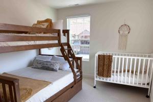 a bedroom with two bunk beds and a crib at The Views at Jordanelle Ridge in Cranmer