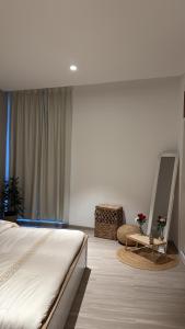 a bedroom with a bed and a mirror and a chair at One way flat in Muscat +7 photos