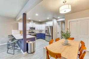 a kitchen with a wooden table and a kitchen with blue cabinets at Boise Blue Retreat - North End - Hot Tub - 13 St in Garden City
