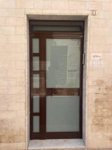 a door to a building with a sign on it at La Viuzza Rooms in Barletta +5 photos