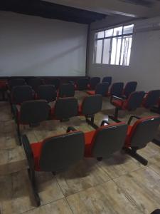 an empty room with chairs and tables in it at Arvore da Vida Pousada in Itaguaí