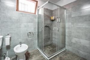 a bathroom with a shower and a toilet at Keshtjella Xhabeqos in Tirana +41 photos