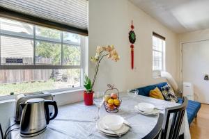 a dining room with a table with a bowl of fruit on it at 5 Mi to Dtwn Oakland Studio with Shared Patio in Oakland