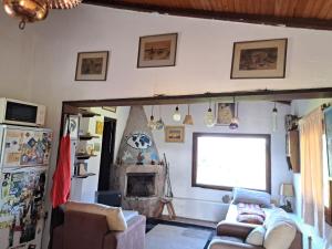 a living room with a couch and a fireplace at La Mansión in Riachuelo