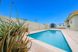 a swimming pool in the backyard of a house at Pool Home Near Palm Beach Plaza – Sleeps 13 in Saliña Cerca