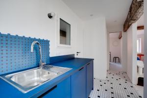 a blue and white kitchen with a sink at Madeleine Bleue - Heart of Toulouse - Air conditioning, WiFi in Toulouse
