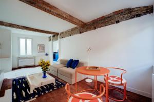 a living room with a couch and a table at Madeleine Bleue - Heart of Toulouse - Air conditioning, WiFi in Toulouse +16 photos