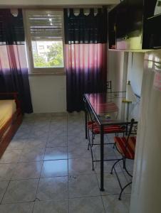 a room with a table and chairs and a window at Mardel Casino in Mar del Plata