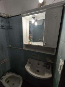 a bathroom with a sink and a mirror at Mardel Casino in Mar del Plata +1 photo