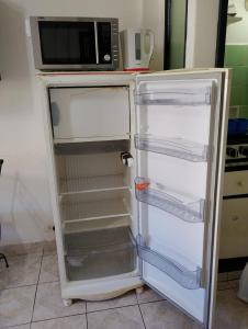 an open refrigerator with a microwave on top of it at Mardel Casino in Mar del Plata