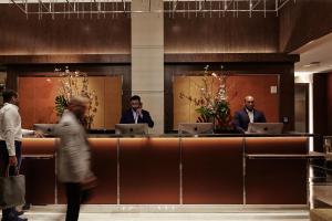 a group of people standing at a reception desk at The Joule in Dallas +59 photos