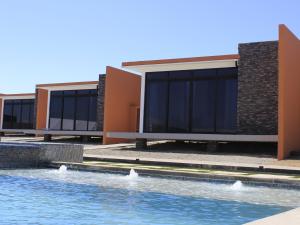 a row of buildings with a swimming pool in front at Ariché en Valle de Guadalupe in Valle de Guadalupe