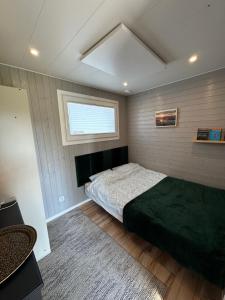 a bedroom with a large bed and a window at Domek Veli Stawinoga in Stawinoga