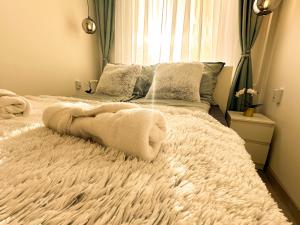 a bedroom with a bed with towels on it at VIBE S31 Apartman ,AC,Free Parking in Székesfehérvár