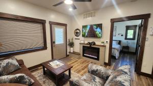 a living room with a couch and a fireplace at Parkside Cabins in West Yellowstone
