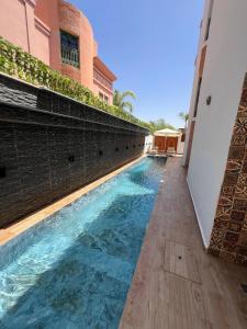a swimming pool in front of a building at Royal Arabian Night in Marrakech