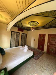 a bedroom with a white bed in a room at Royal Arabian Night in Marrakech