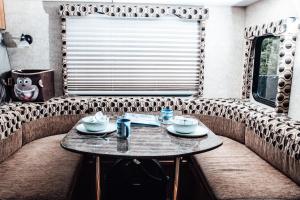 a table in the back of an rv at Nicevilles' Hidden Backyard Camper in Niceville +4 photos