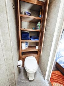 a bathroom with a toilet in a room at Nicevilles' Hidden Backyard Camper in Niceville