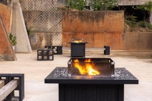 a fire pit in a courtyard with benches at Heart of Downtown, Walk to Bathhouses, Restaurants Room # 202 in Hot Springs