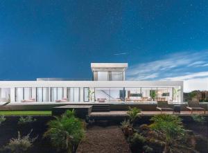 a large white house with a lot of windows at Villa White Lava by Aura Collection in Lajares +59 photos