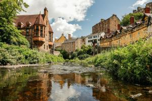 a river in the middle of a city with buildings at Garner Hotel Edinburgh - Haymarket by IHG in Edinburgh